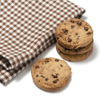 chocolate chip cookies with kitchen towel on a white background