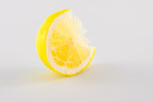 Slice of fresh lemon yellow on white background