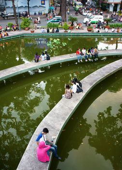 HO CHI MINH CITY, VIET NAM- OCT7: Lifestyle of young Asian people at urban, group of teenager sitting at Ho Con Rua to relax, talk with friend, fresh air in evening, amazing scene, Vietnam, Oct7, 2014