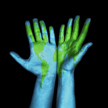 World map painted on human hands. Isolated on black background