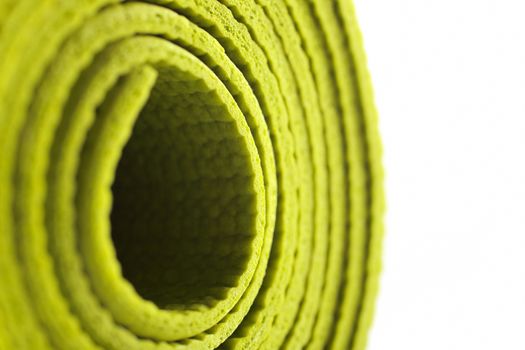 Green exercise mat isolated on white background. 