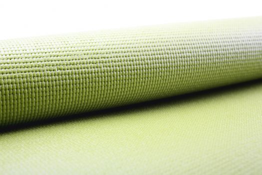 Green exercise mat isolated on white background. 