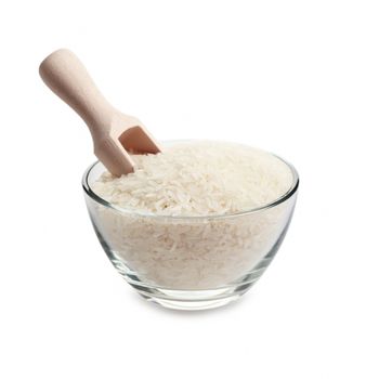 White rice and wooden scoop in glass bowl isolated on white background.