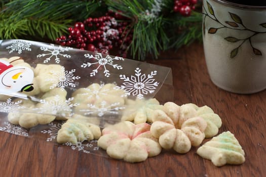 Christmas cookies spilling out of a bag onto a wooden table.