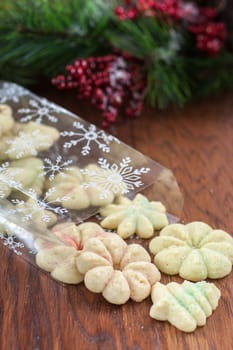 Christmas cookies spilling out of a bag onto a wooden table.