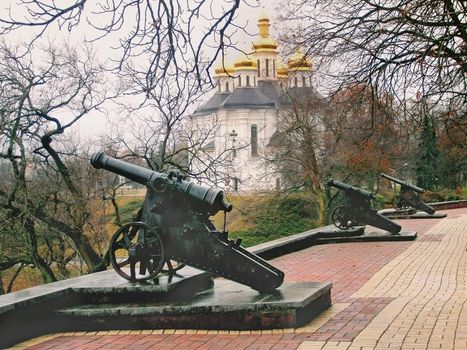 Waterfront with old cannons and the Orthodox Church in the city of Chernihiv, Ukraine.