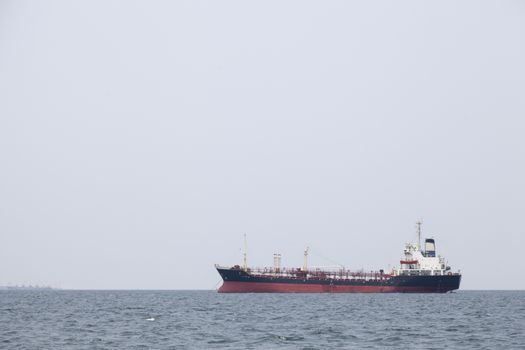 Large cargo ship Boats moored in the sea to make sense compared to the coast.