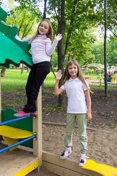 Photo of two playing girls in summer