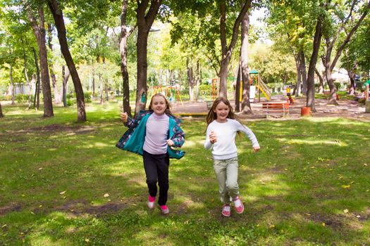 Photo of cute two running girls in summer