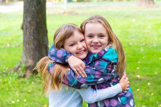 Photo of two playing girls in summer