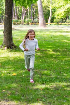 Photo of cute running girl in summer
