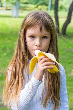 Photo of girl are eating banana in summer