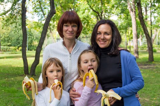 Photo of group people are eating bananas in summer