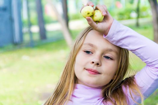 Photo of cute girl with apples in summer
