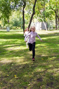 Photo of cute two running girls in summer