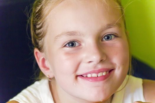 Cute girl with blond long hair and blue eyes