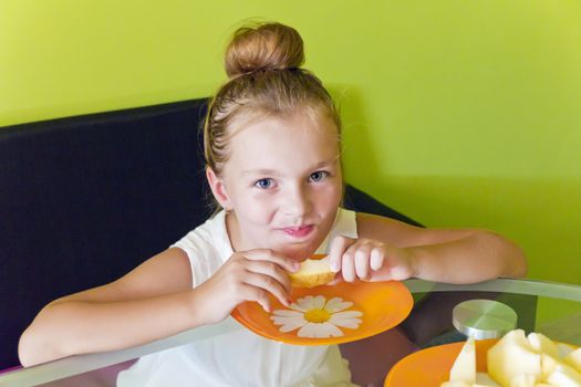 Photo of the cute girl eating melon