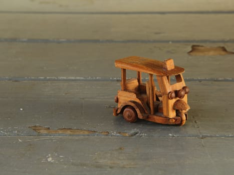 Thai tricycle wood toy on the table.
