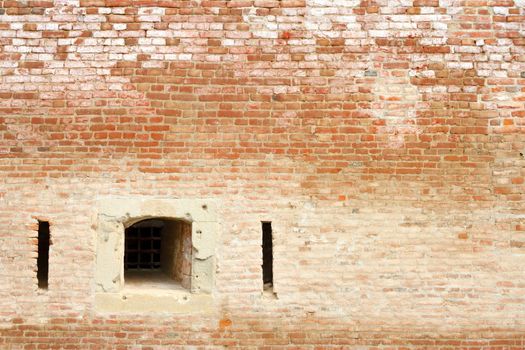 window on ancient brick wall, facade of old castle