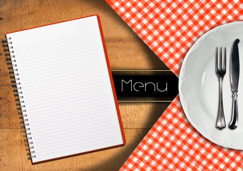 Food menu with white plate, silver cutlery and empty notebook on wooden background with tablecloth and horizontal black band