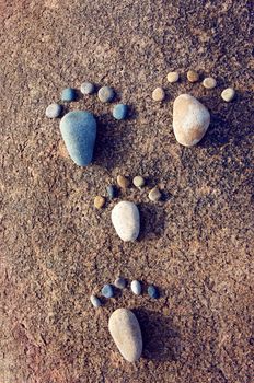 Amazing concept from stone, group of pebble as family illustration, foot step on rock, funny toe, pretty idea for design