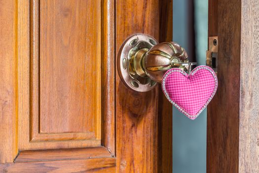 close up key of love on door handle, doorknoob