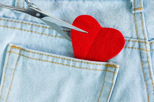 scissors cut heart love on jeans background