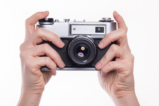 Classic 35mm old analog camera on white - studio shoot 