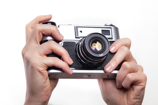 Classic 35mm old analog camera on white - studio shoot 