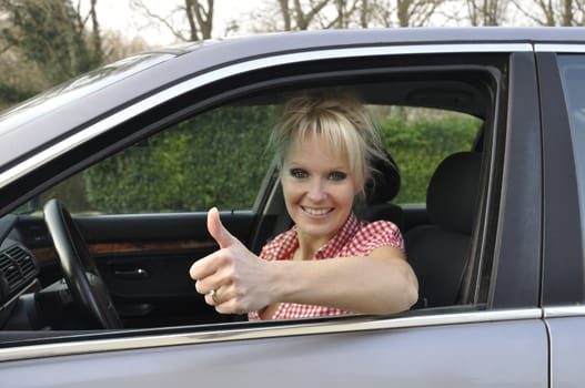 woman driving a gray car