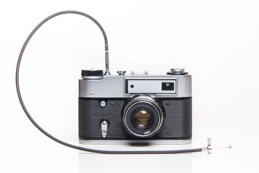 Classic 35mm old analog camera on white - studio shoot 