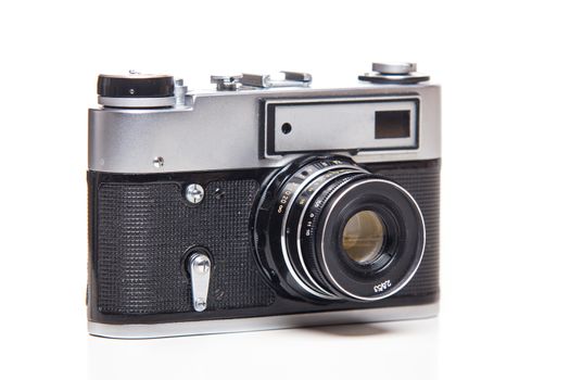 Classic 35mm old analog camera on white - studio shoot 