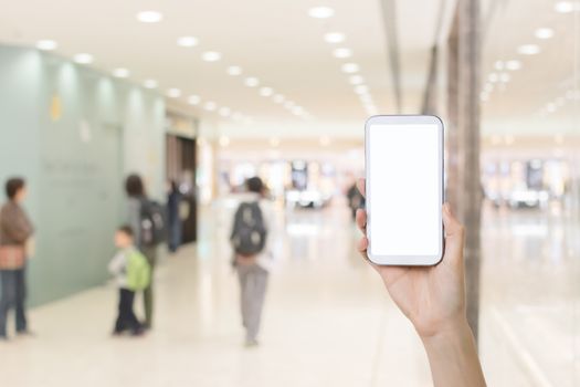 Using smartphone in a market or department store, closeup image.