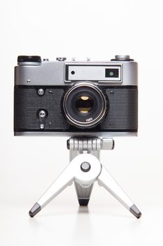 Classic 35mm old analog camera on tripod - studio shoot