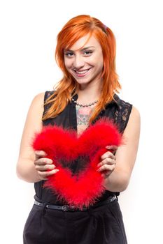 Smiling pretty girl holding a heart made of bird feathers