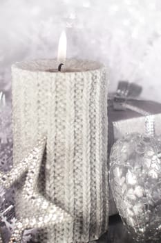 Beautiful shiny silver christmas decor and burning candle