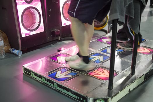 LONDON UK - NOVEMBER 15: Legs of participants playing dancing video game in Hyper Japan. November 15, 2014 in London. Held in Kensington Olympia this year, the event celebrates all things Japanese.