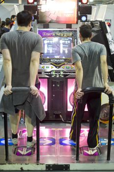 LONDON UK - NOVEMBER 15: Participants playing dancing video game in Hyper Japan. November 15, 2014 in London. Held in Kensington Olympia this year, the event celebrates all things Japanese.