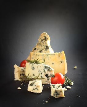 Roquefort cheese composition on dark background