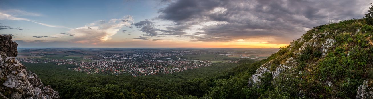 City of Nitra from Above at Sunset with Rocks and Plants in Foreground as Seen from Zobor Mountain