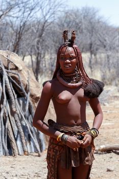 NAMIBIA, KAMANJAB, OCTOBER 10: Himba tribe woman with ornaments on the neck, in the village of Himba people near Kamanjab in northern Namibia, August 10, 2014, Namibia