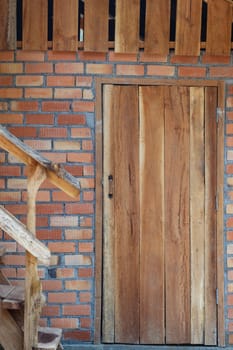 wood door on brick wall of house