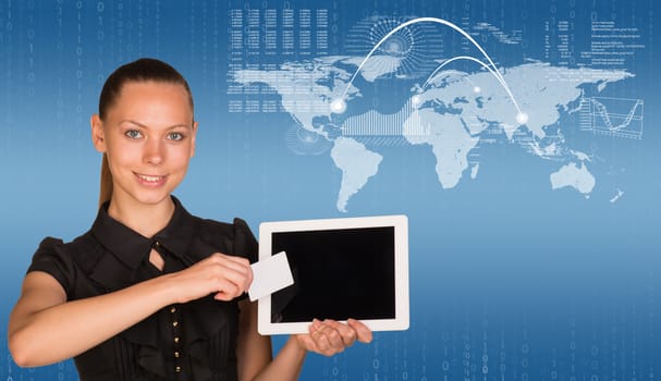 Beautiful businesswoman in dress holding tablet and white empty card near screen of tablet. World map, graphs and figures as backdrop