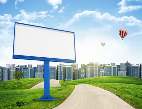 Tall buildings, green hills and road with large billboard against sky with clouds. Architectural concept