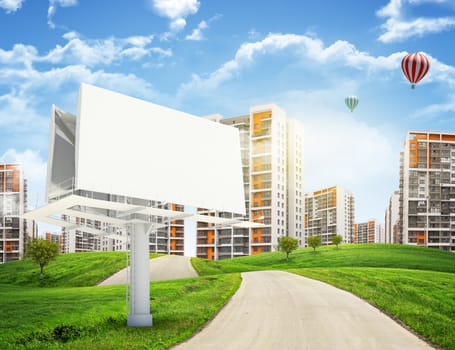 Tall buildings, green hills and road with large billboard against sky with clouds. Architectural concept