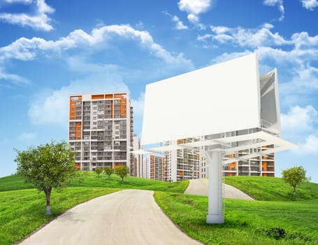 Tall buildings, green hills and road with large billboard against sky with clouds. Architectural concept