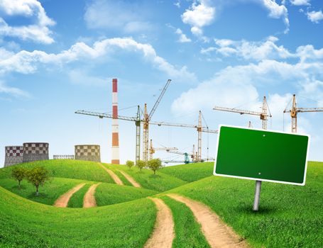 Industrial zone, green hills and road with empty road sign against sky with clouds. Business concept