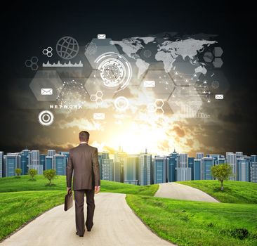 Businessman walks on road. Rear view. Buildings, grass field and dramatic sky with virtual elements. Business concept