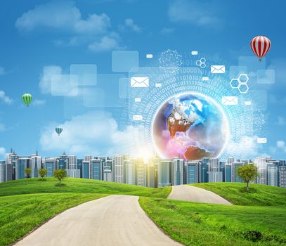 Road with green grass. Buildings and Earth with virtual elements as backdrop. Business concept. Elements of this image furnished by NASA