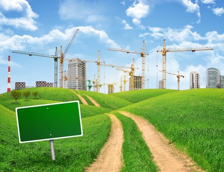 Industrial zone, green hills and road with empty road sign against sky with clouds. Business concept